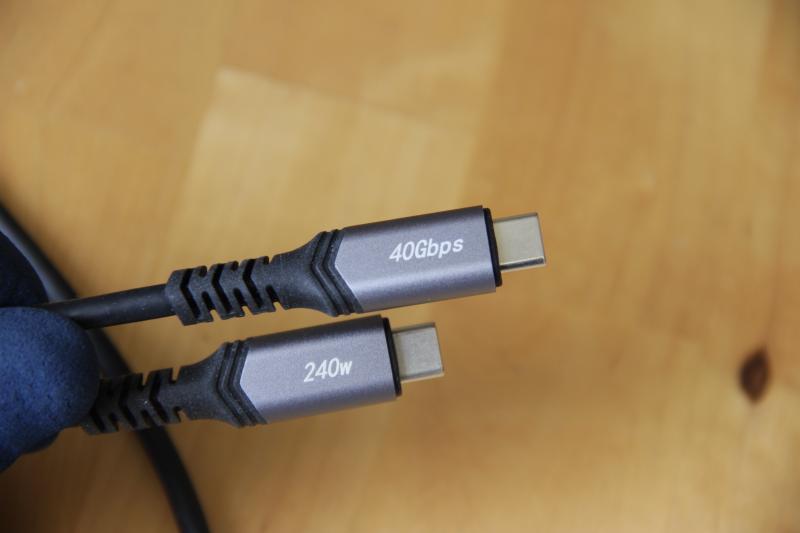 Photographie des deux connecteurs d'un câble USB de type C. Sur l'un des connecteurs est indiquée la mention « 40Gbps » et sur l'autre est indiquée la mention « 240w ».